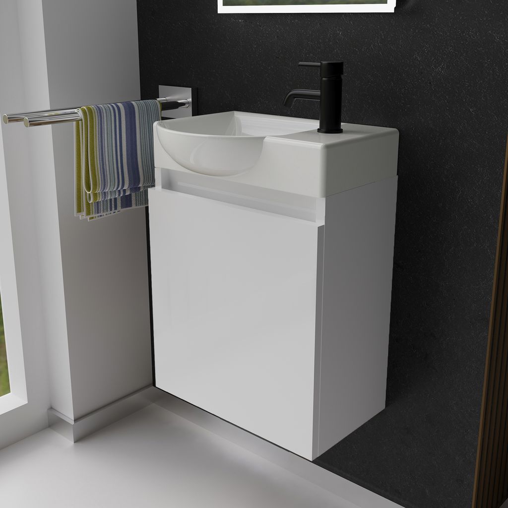 A modern white vanity unit with a sink and black faucet in a bathroom setting.