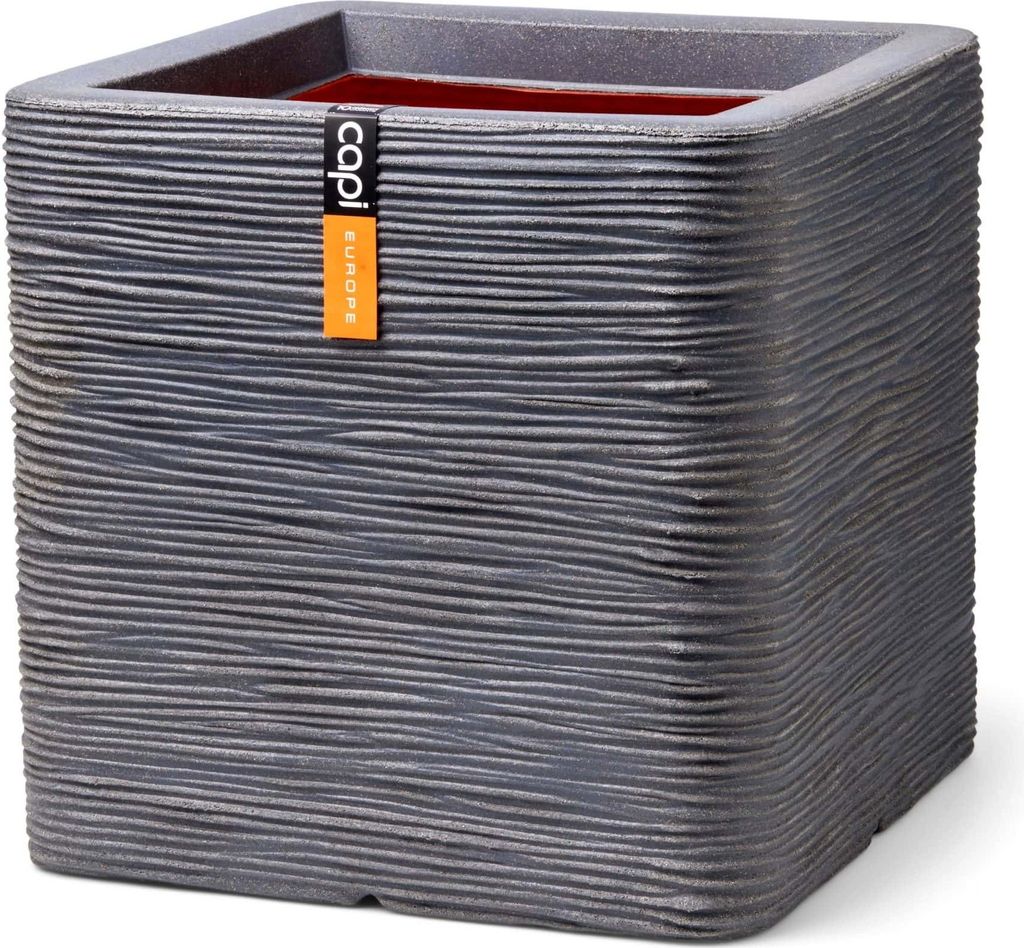 A square planter with a textured surface and a tag attached.