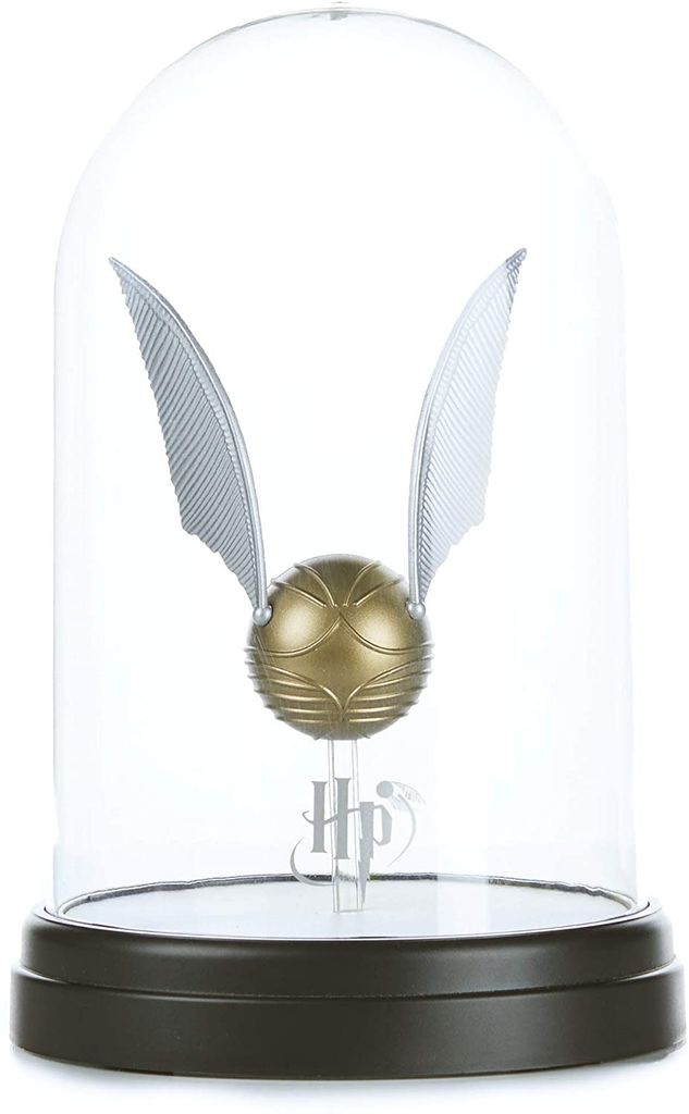 A golden snitch with silver wings displayed under a glass dome on a black base.