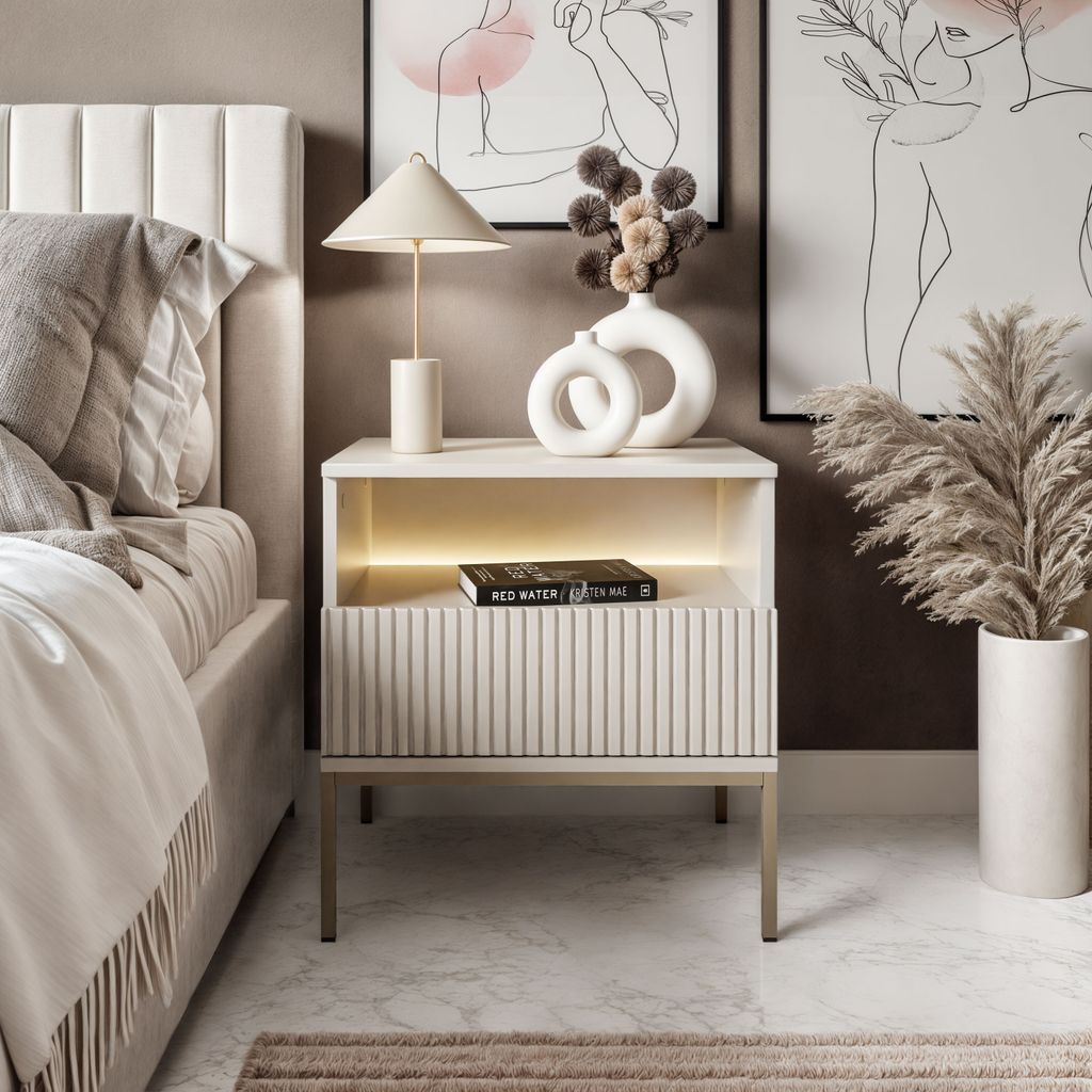 A bedroom scene featuring a nightstand next to a bed.