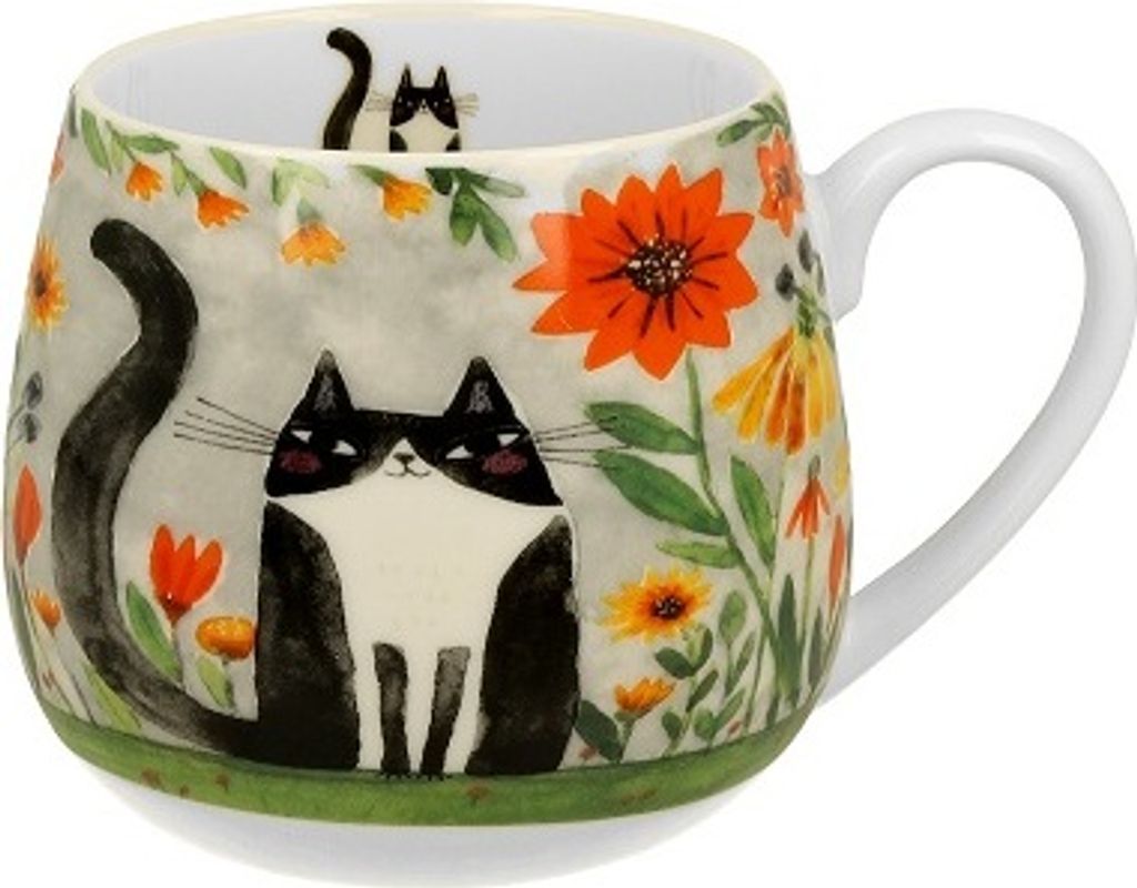 A ceramic mug with a black and white cat design and floral motifs.