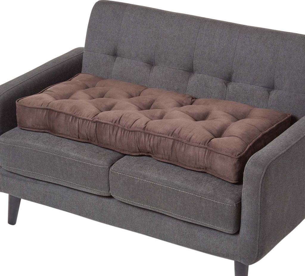 A brown tufted sofa cushion placed on a gray sofa.