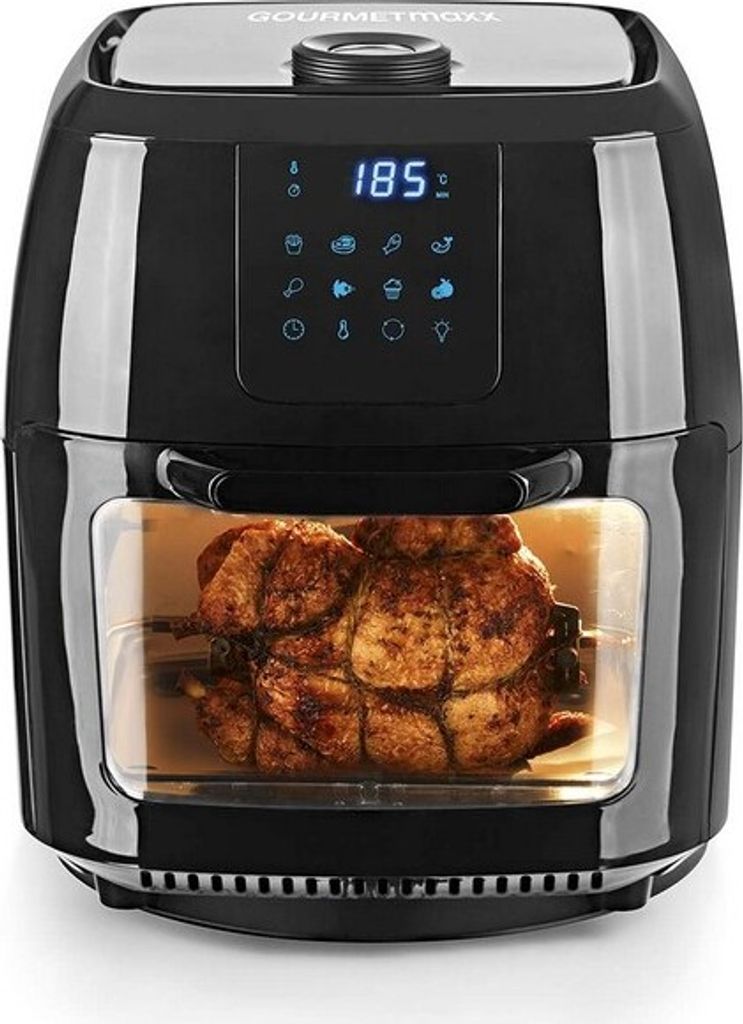 A black air fryer with a rotisserie chicken inside.