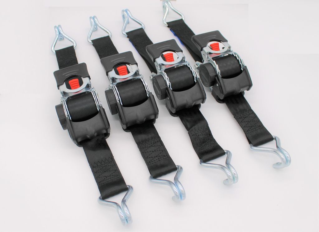 Four black ratchet straps with silver metal hooks and red release buttons are laid out diagonally on a white background.