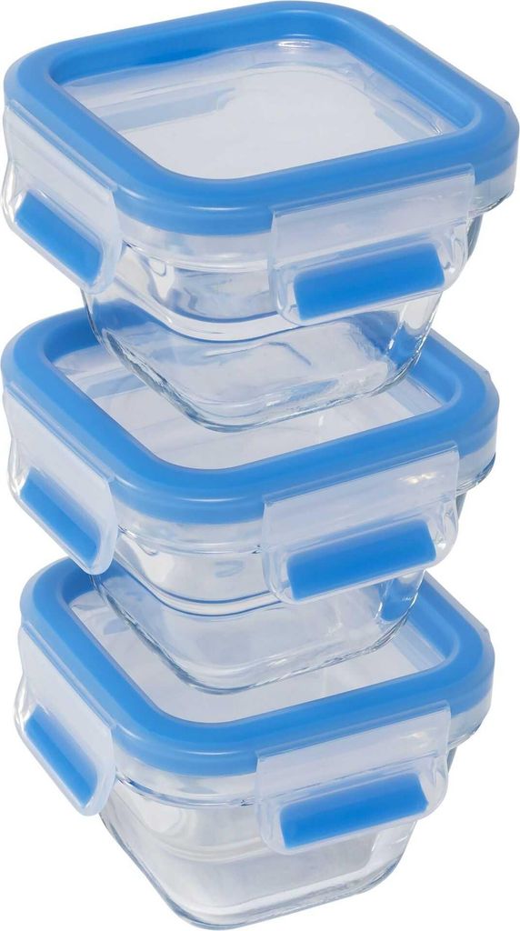 A stack of three clear glass food storage containers with blue lids.
