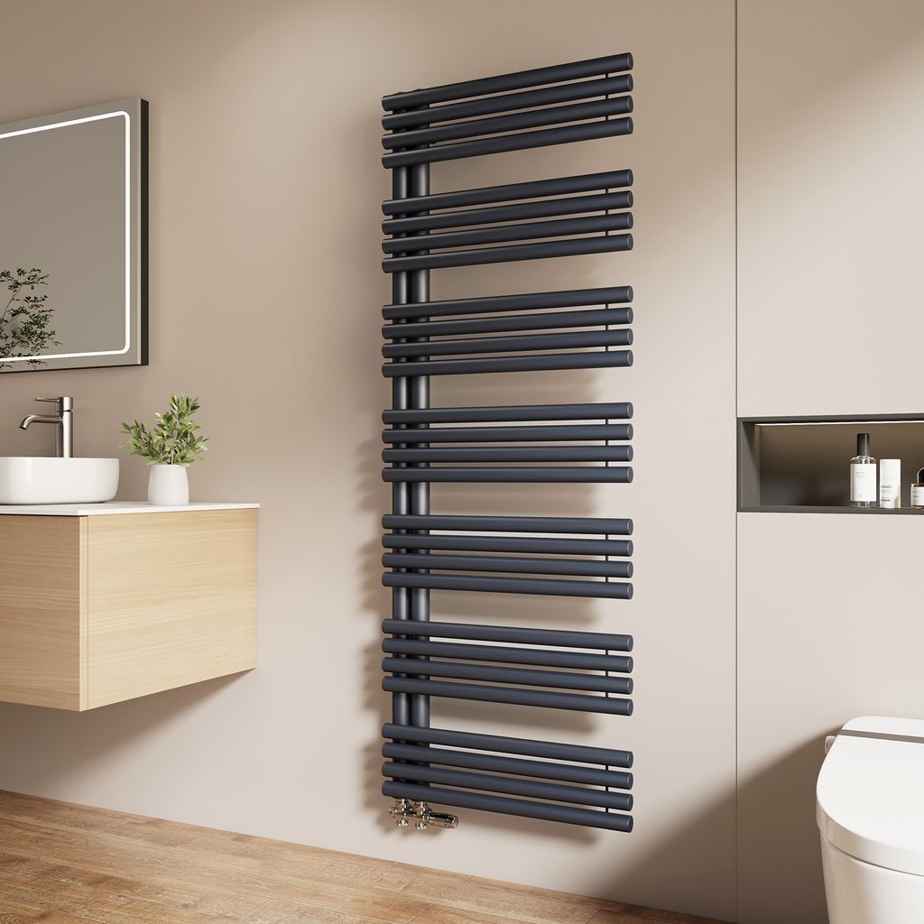 A modern bathroom with a sink, mirror, and a dark gray towel radiator.