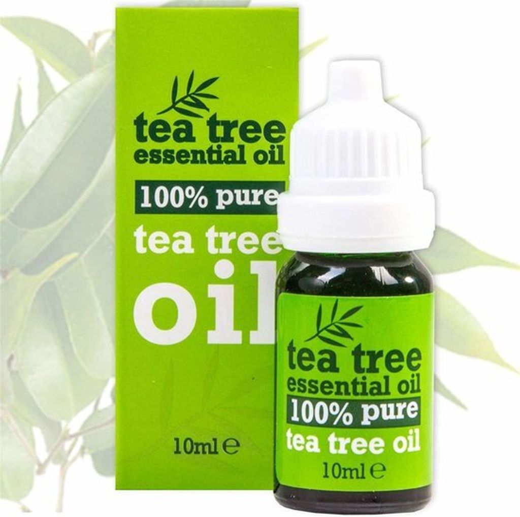 A bottle of tea tree essential oil next to its packaging.