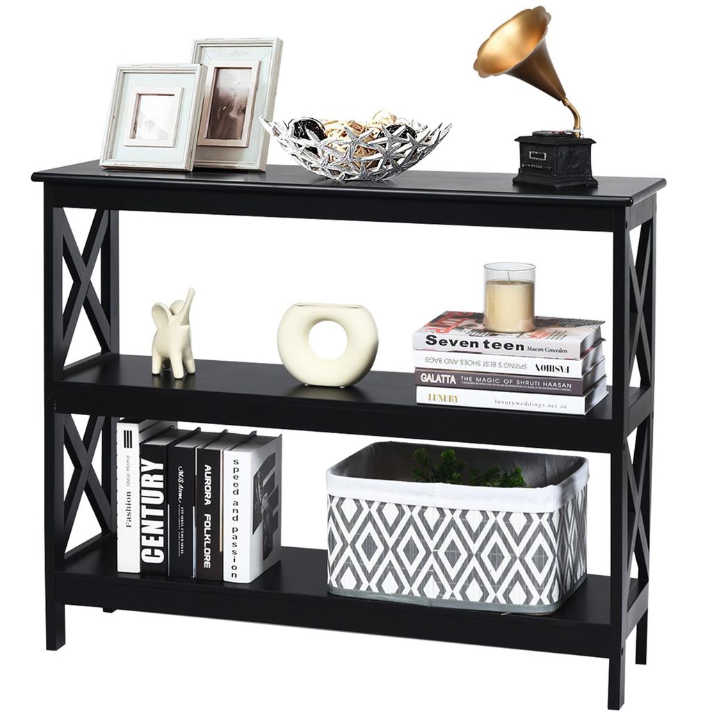 A black console table with three shelves, decorated with various items.