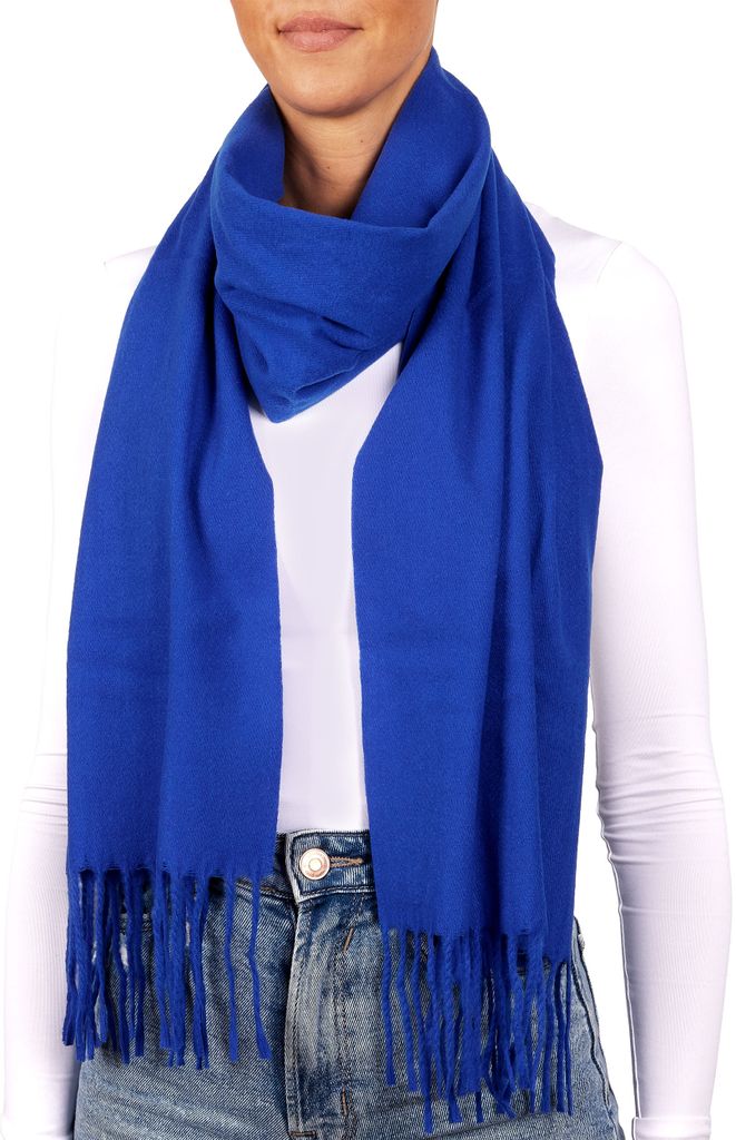 A person wearing a white shirt and blue jeans, with a blue scarf draped around their neck.