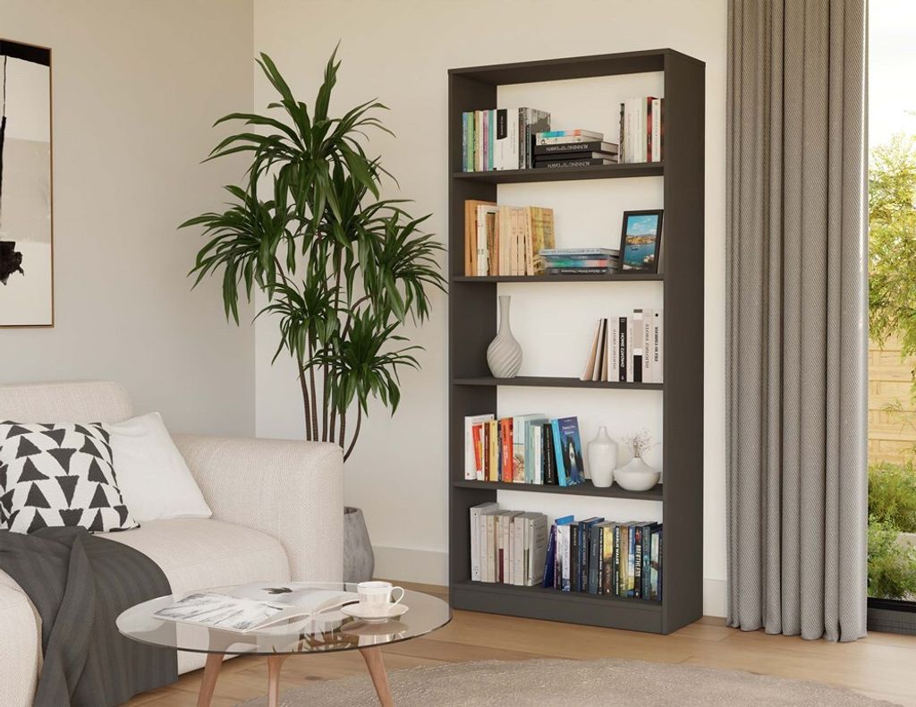 A living room scene with a bookshelf, sofa, and coffee table.
