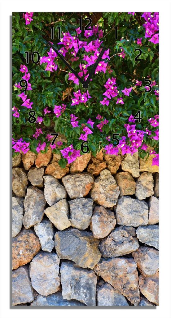 Wallario Design Wanduhr Mauer mit pinken Blüten aus Echtglas, Größe 30 x 60 cm