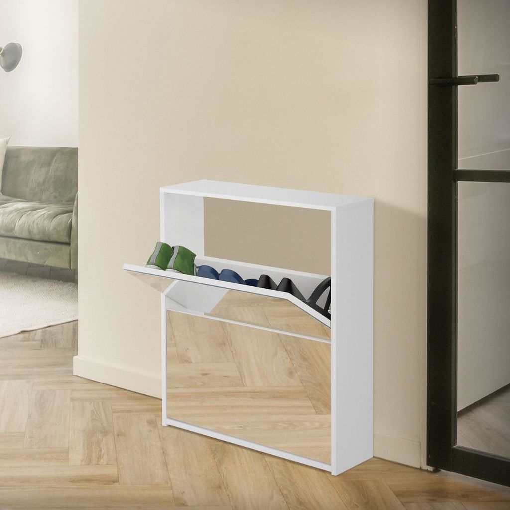 A white shoe cabinet with mirrored doors is shown in a hallway next to a door and a sofa.