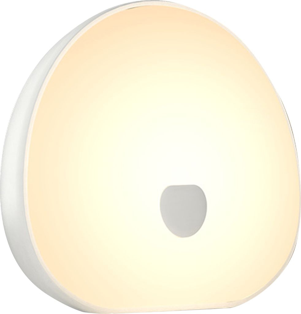 A white, rounded object with a soft, warm light emanating from it, featuring a small, darker circular indentation in the center.