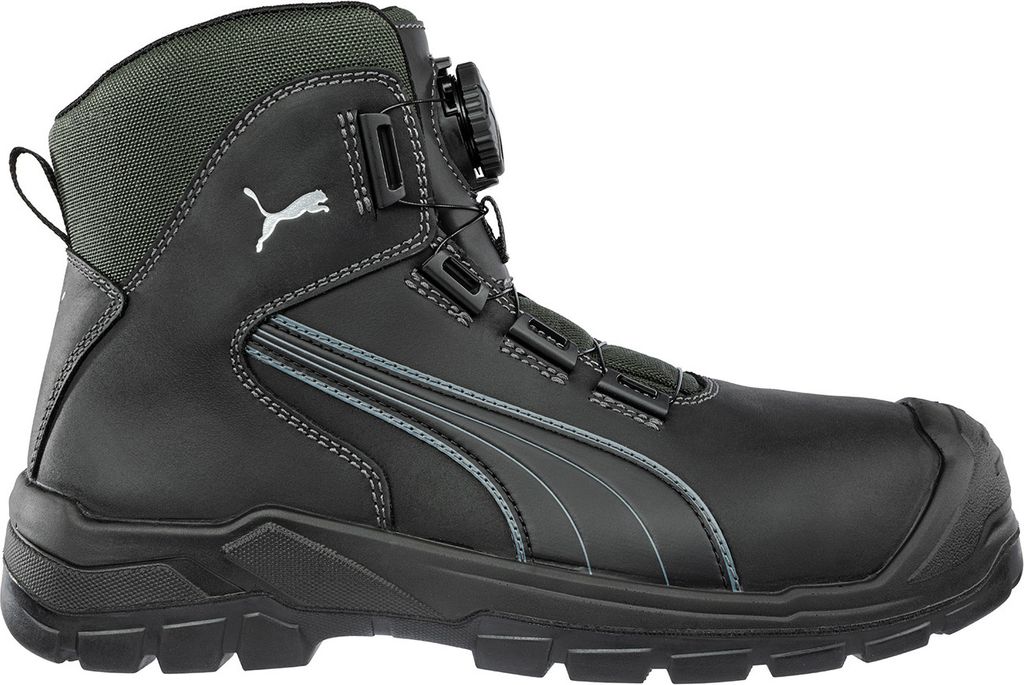 A side view of a black Puma safety boot with gray accents and a green collar.