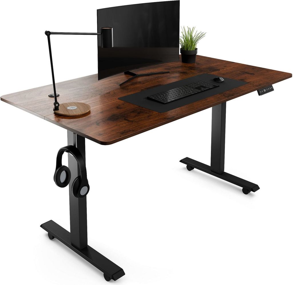 A standing desk with a monitor, keyboard, mouse, lamp, and headphones.