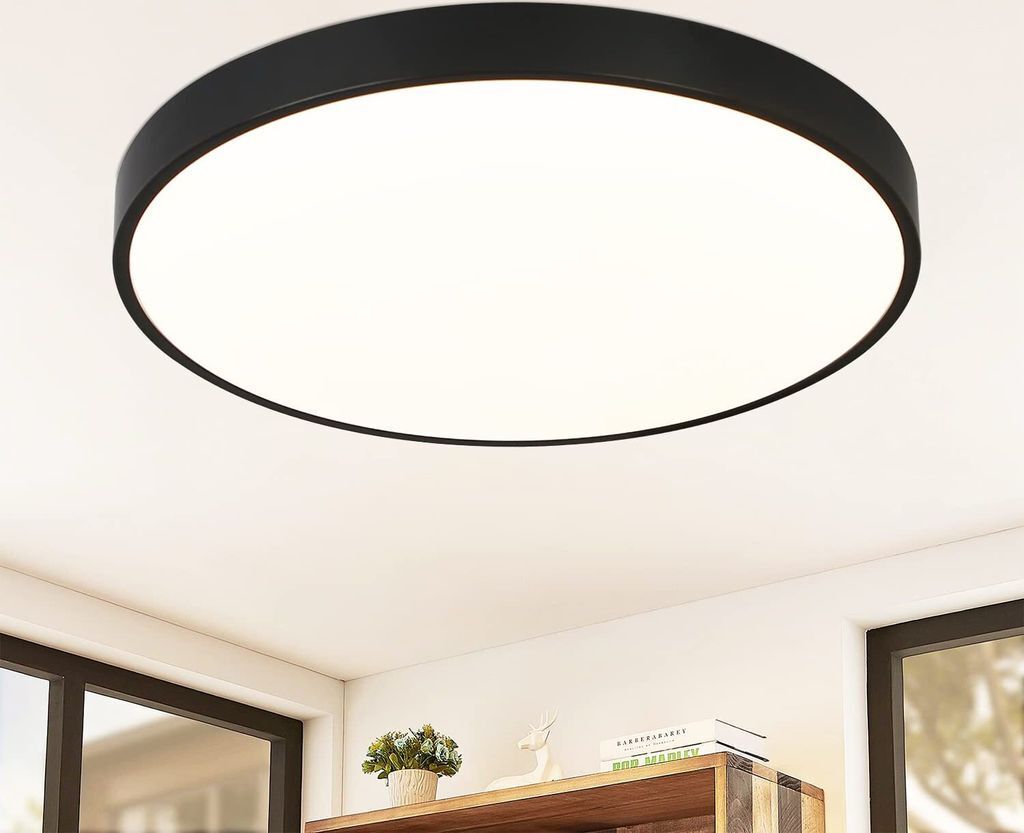 A modern, round, black LED ceiling light is shown mounted on a white ceiling.