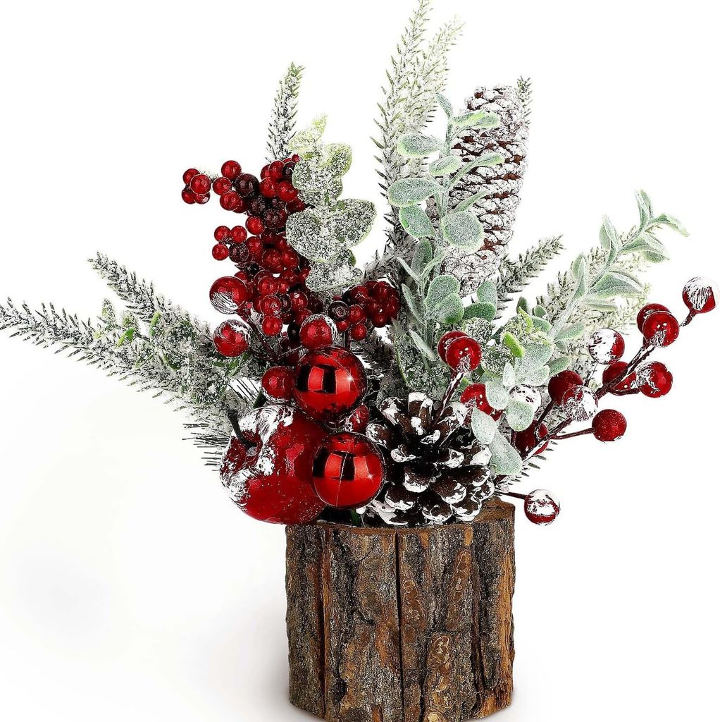A small artificial Christmas decoration in a log holder.