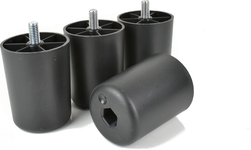 Four black furniture feet are arranged diagonally against a white background, with one in the foreground tilted on its side.