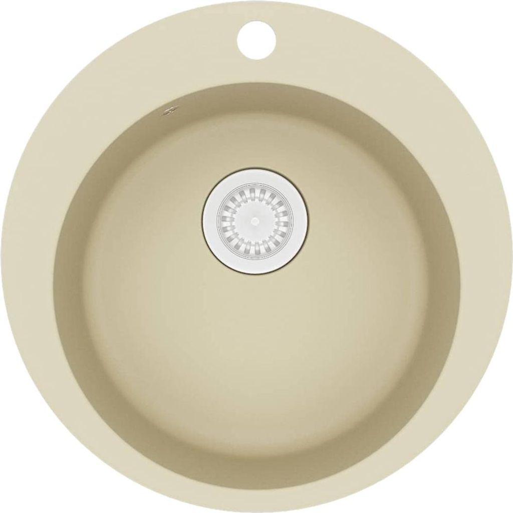 A top-down view of a round, beige granite sink with a white drain assembly in the center and a faucet hole at the top.