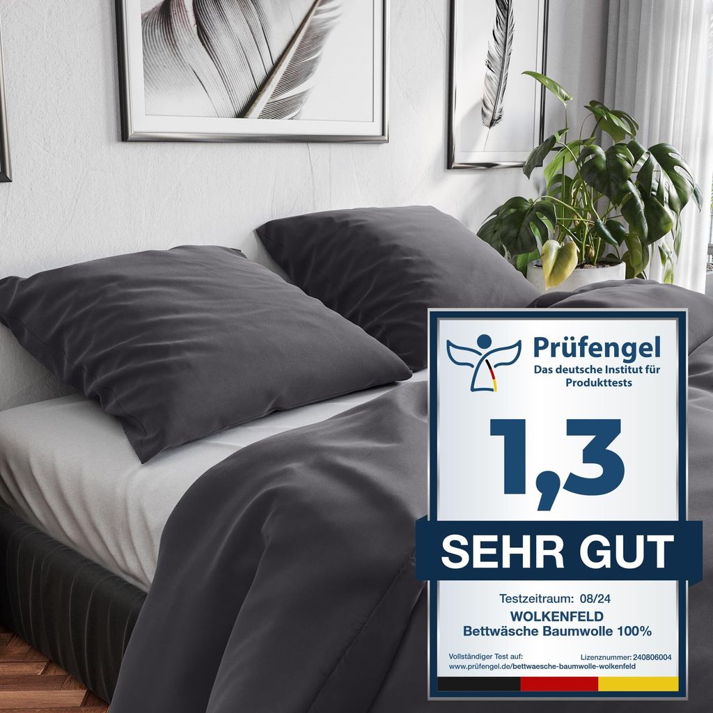 A bed with dark gray bedding and pillows, with a promotional badge on the right.