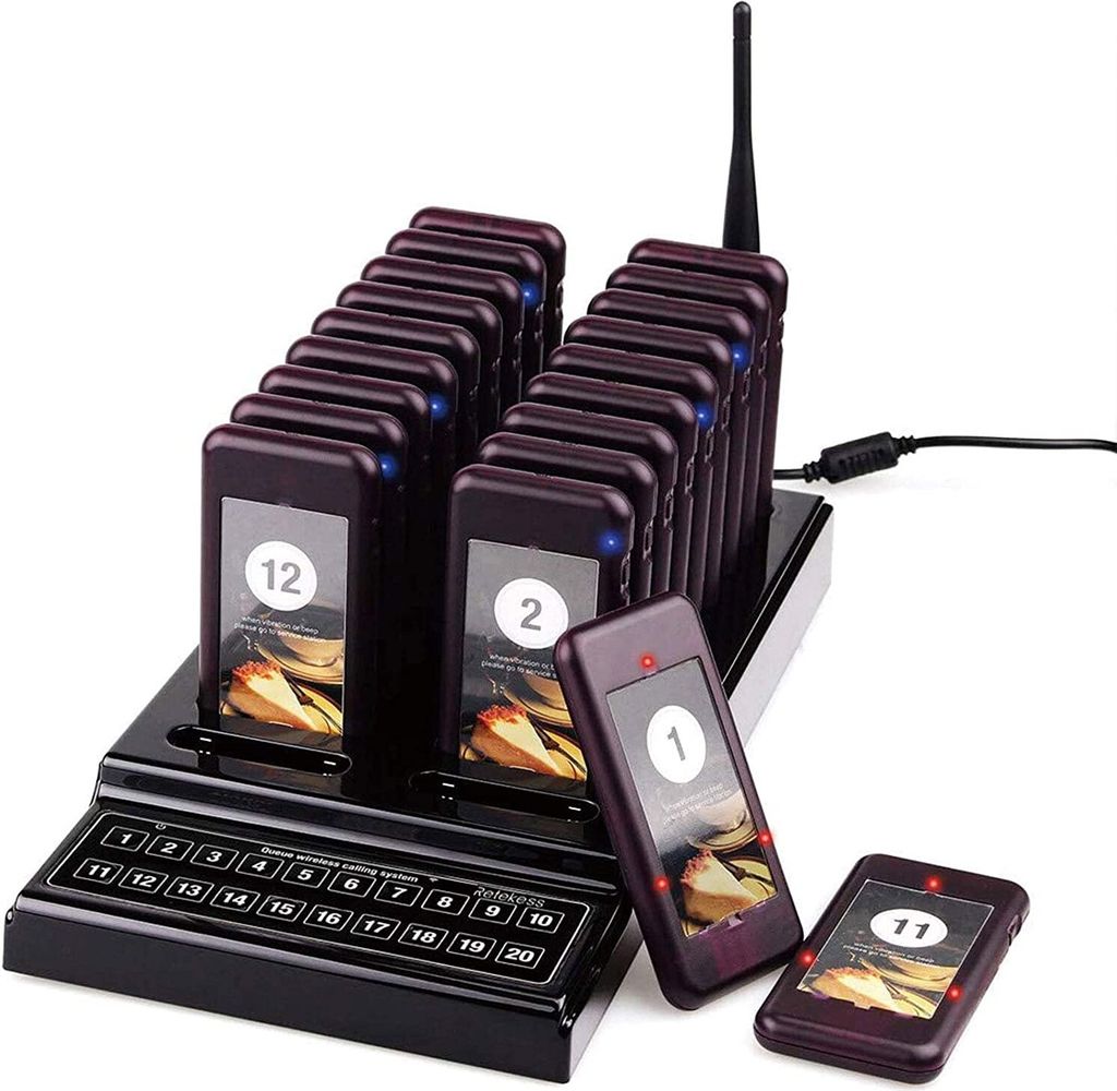 A set of restaurant pagers and their charging base, displayed on a white background.