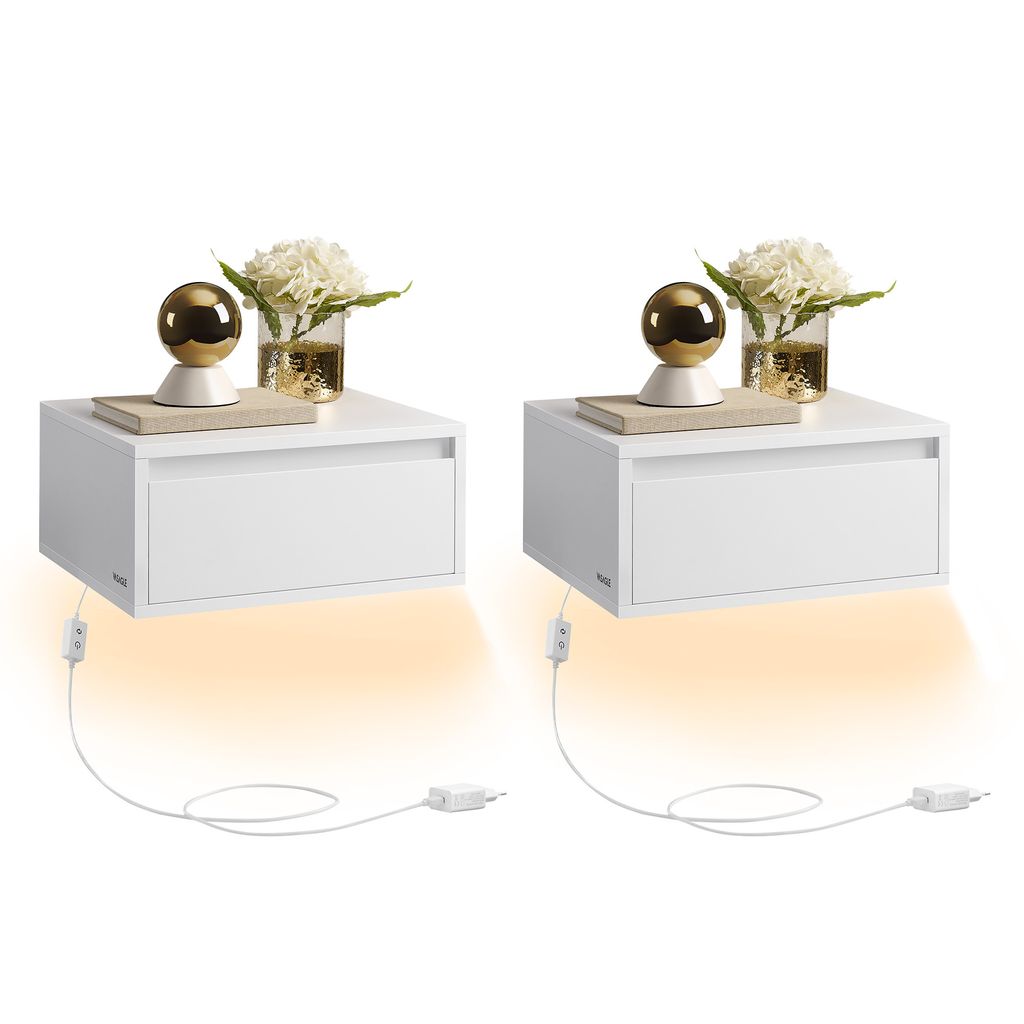 Two white floating nightstands are displayed against a white background. Each nightstand has a drawer and is decorated with a book, a golden orb lamp, and a vase of white flowers. LED lights beneath the nightstands cast an orange glow.