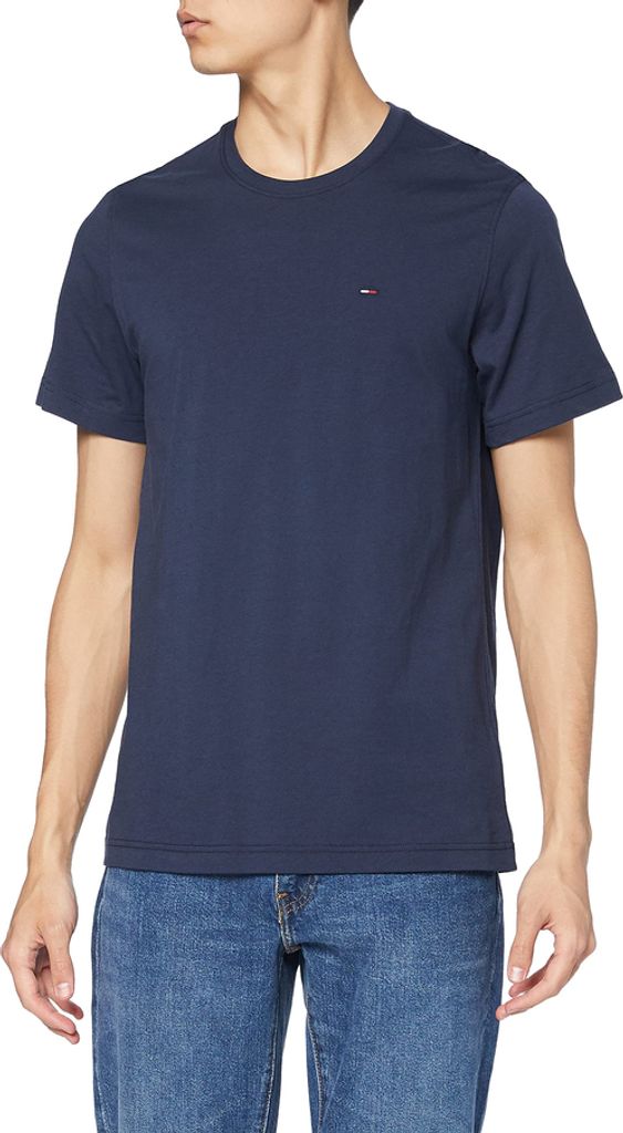 A man wearing a navy blue t-shirt and blue jeans.