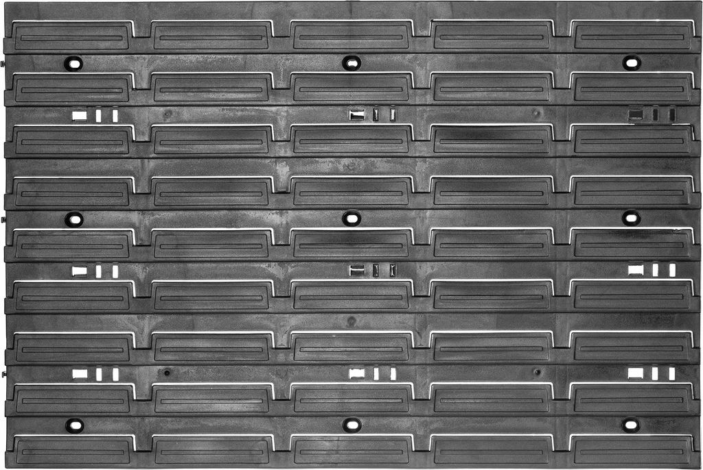 A top-down view of a modular storage system made of dark gray plastic.