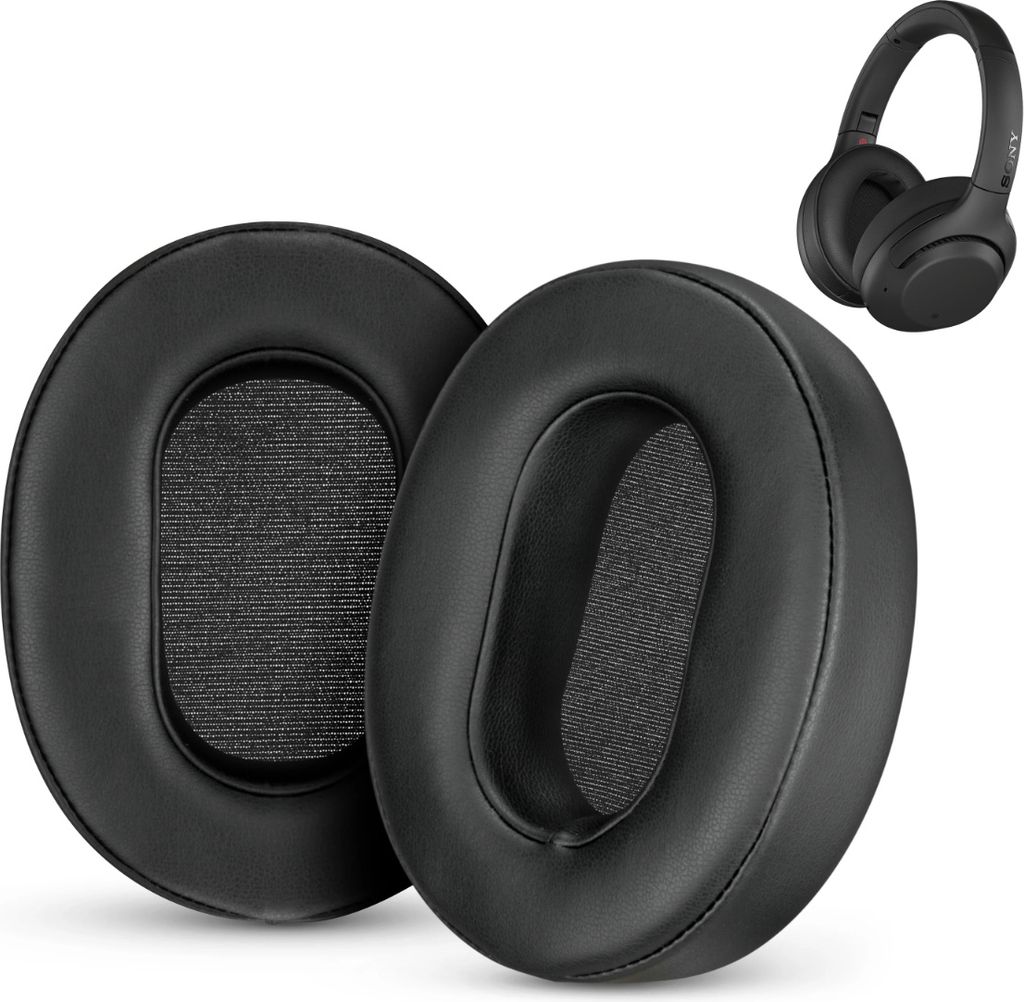 Two black ear pads for headphones are shown in the foreground, with a pair of black headphones in the background.