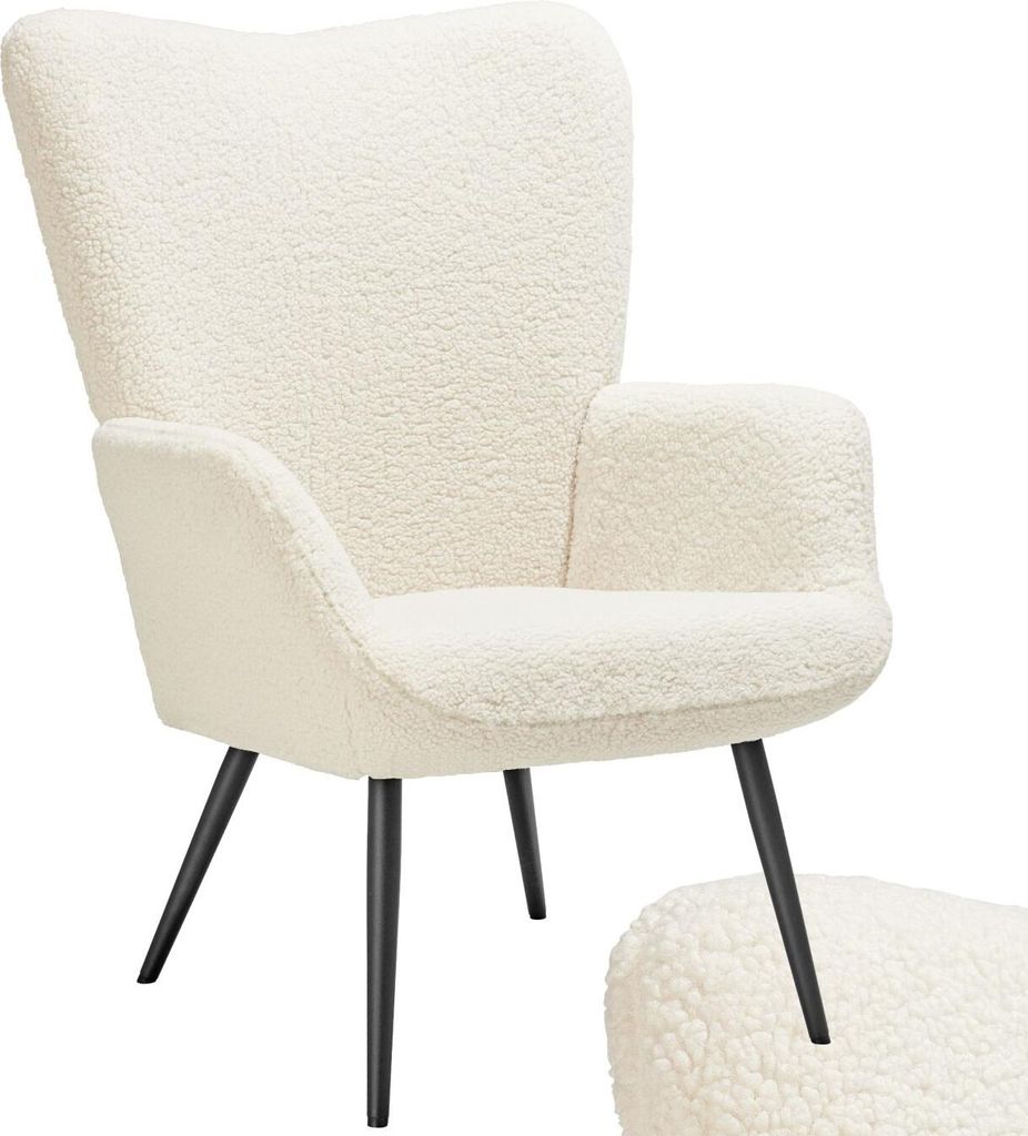 A fluffy cream armchair with black legs.