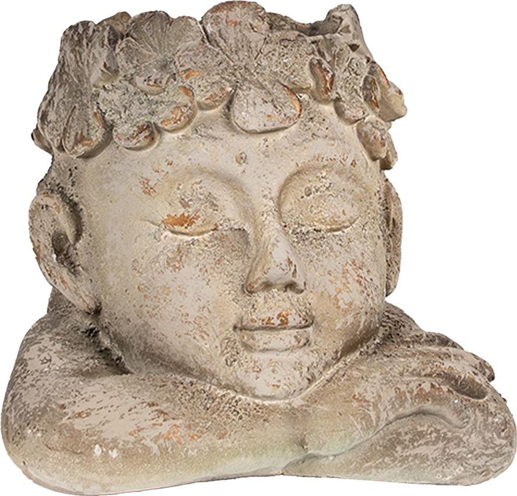 A close-up of a decorative planter shaped like a sleeping head.