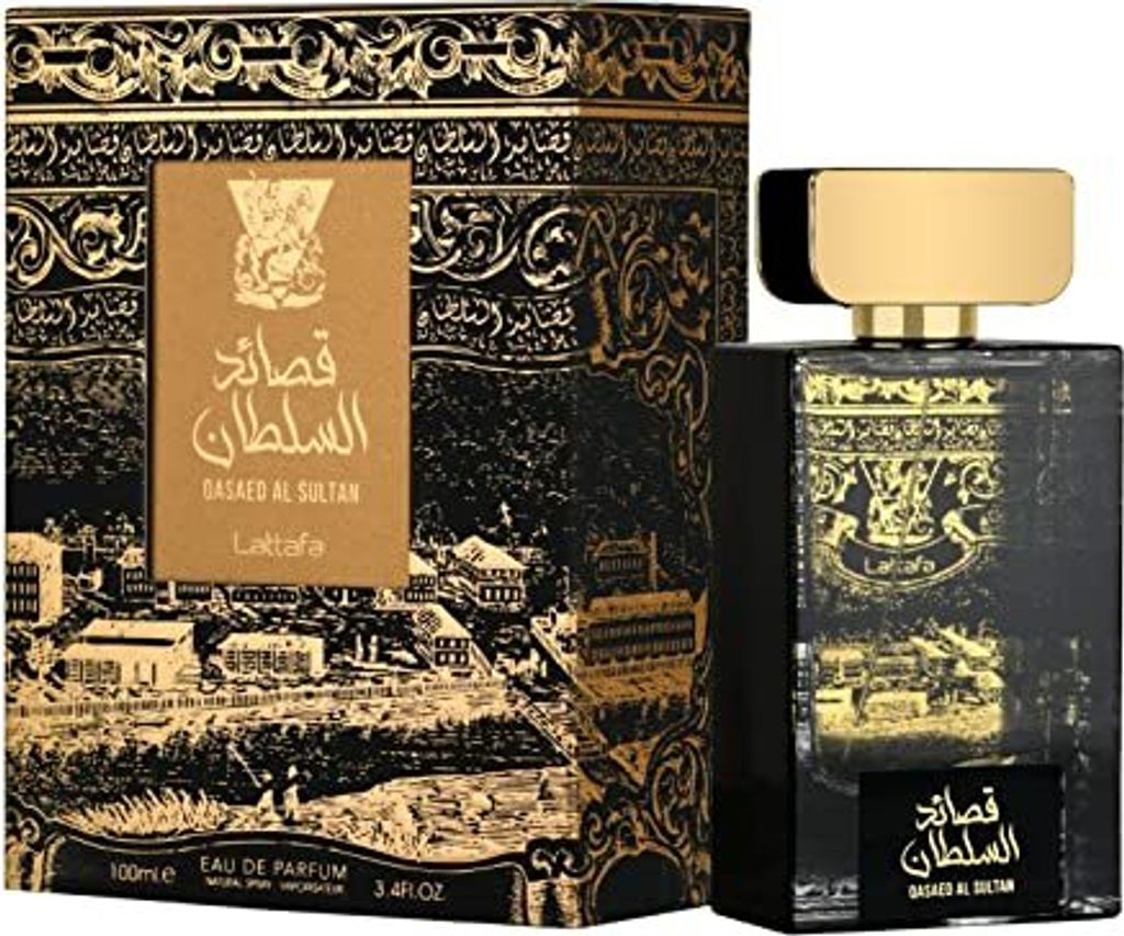 A perfume bottle and its box, both decorated with intricate gold patterns on a black background.