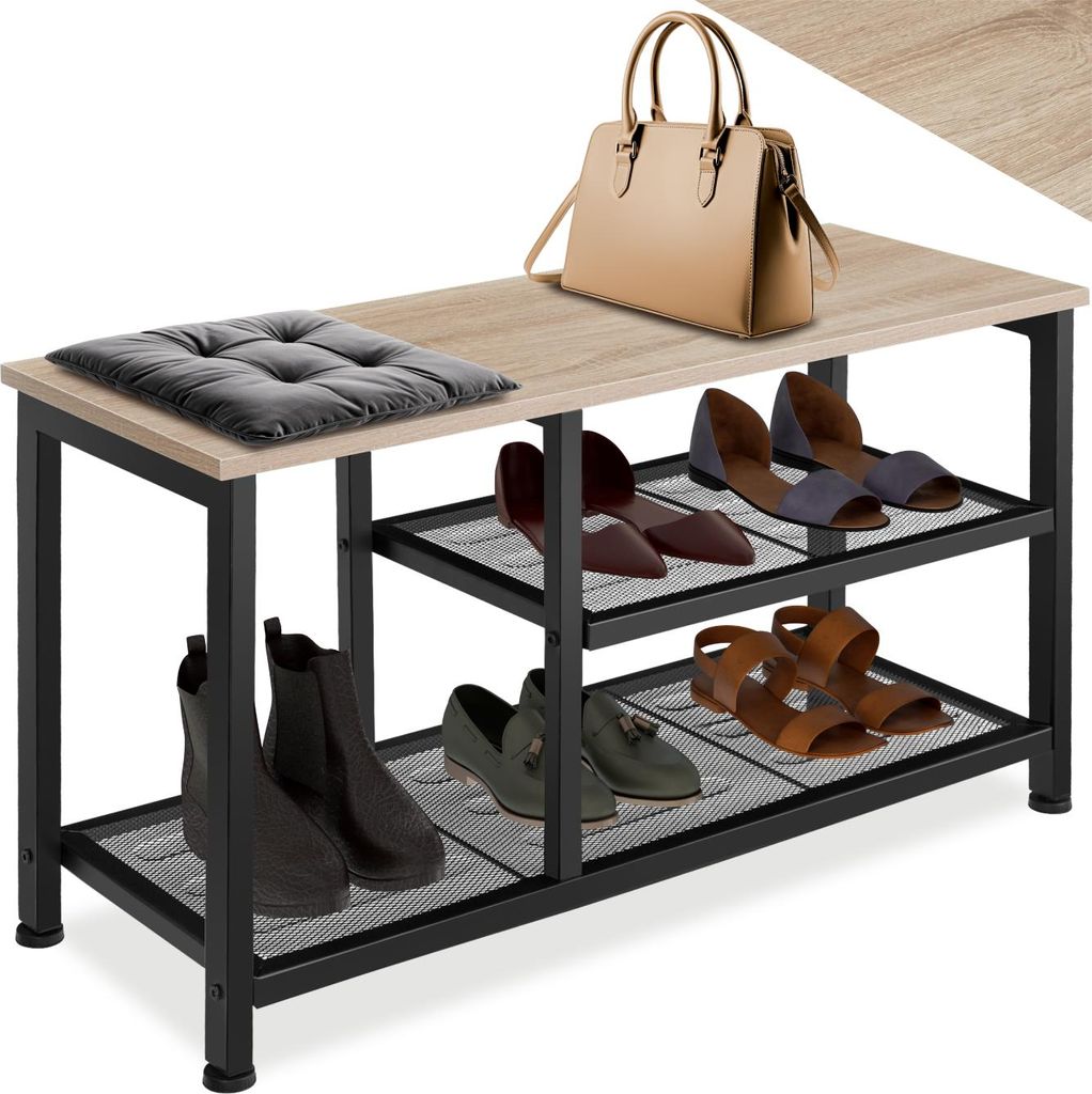 A shoe rack with shoes, a handbag, and a cushion on top.
