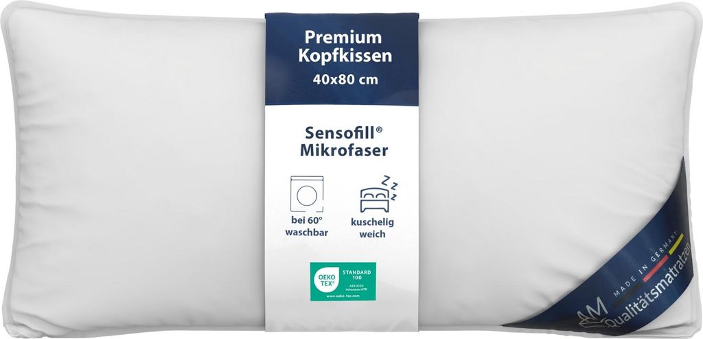 A white pillow with a product tag attached.