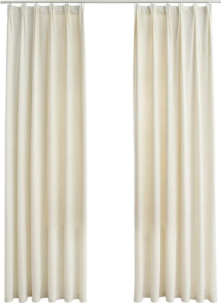 Two cream-colored curtains hanging from a curtain rod against a white background.