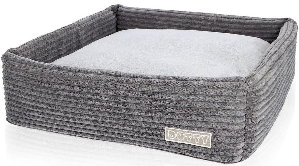 A grey corduroy dog bed with a light grey cushion inside, shown from a slightly elevated angle against a white background.