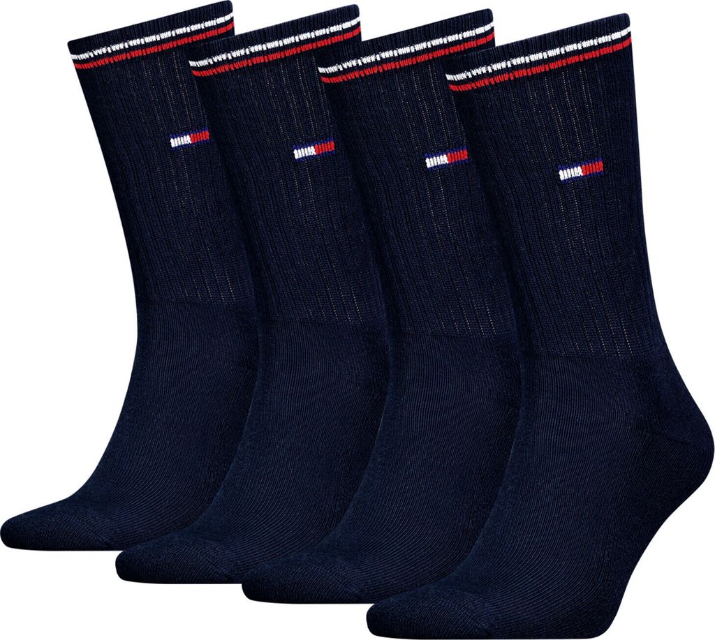 Four navy blue socks are arranged in a row against a white background.