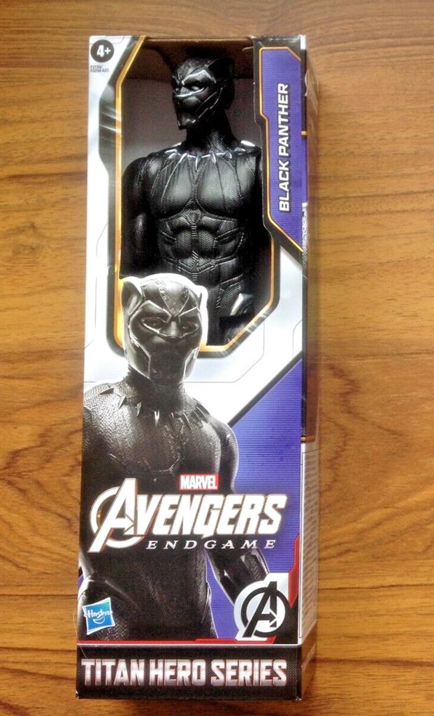 A product box for a Black Panther action figure, displayed on a wooden surface.