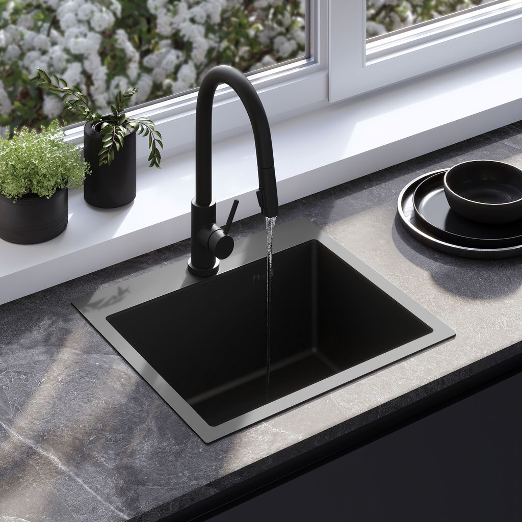A modern kitchen sink with a black faucet, set against a window with white flowers.