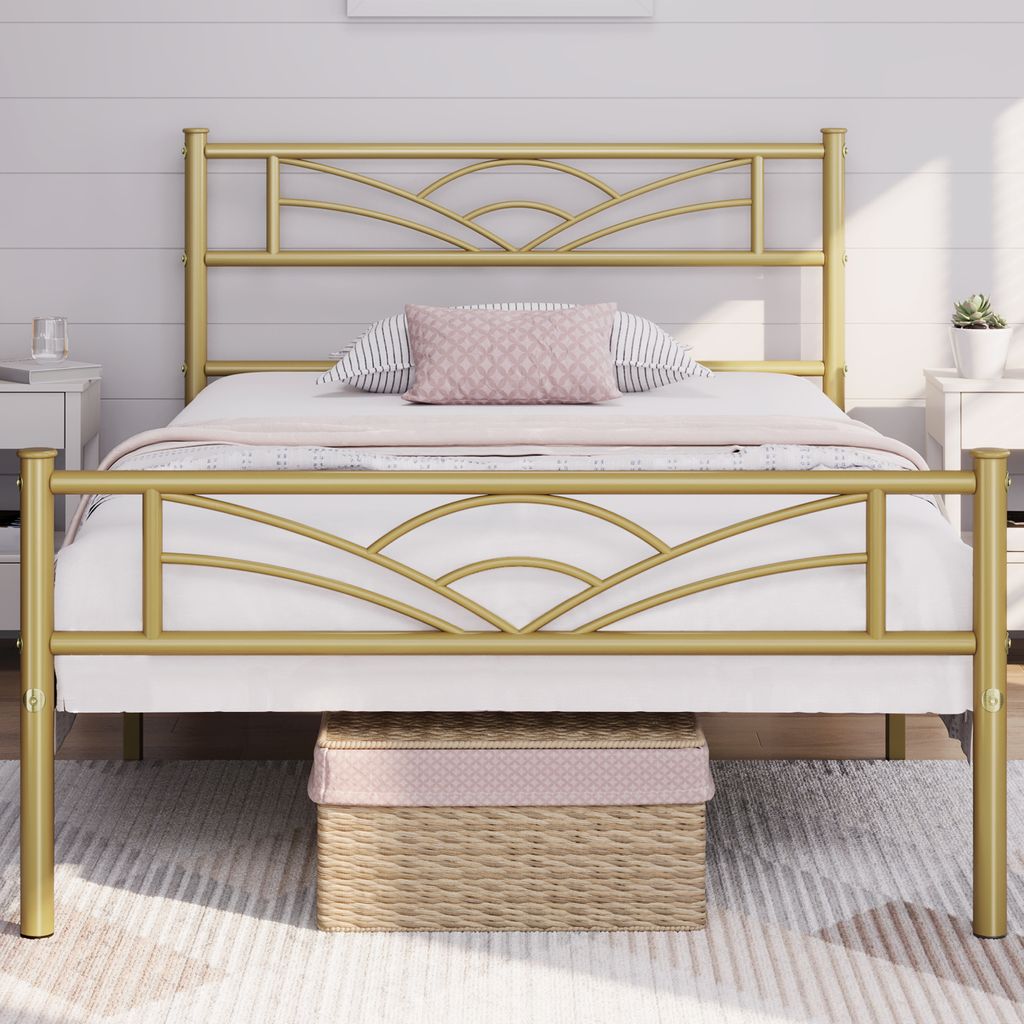 A gold metal bed frame with a cloud pattern headboard is shown in a bedroom setting.