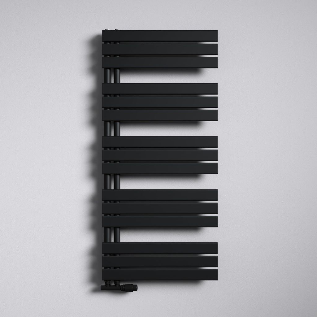 A black modern radiator mounted on a white wall.