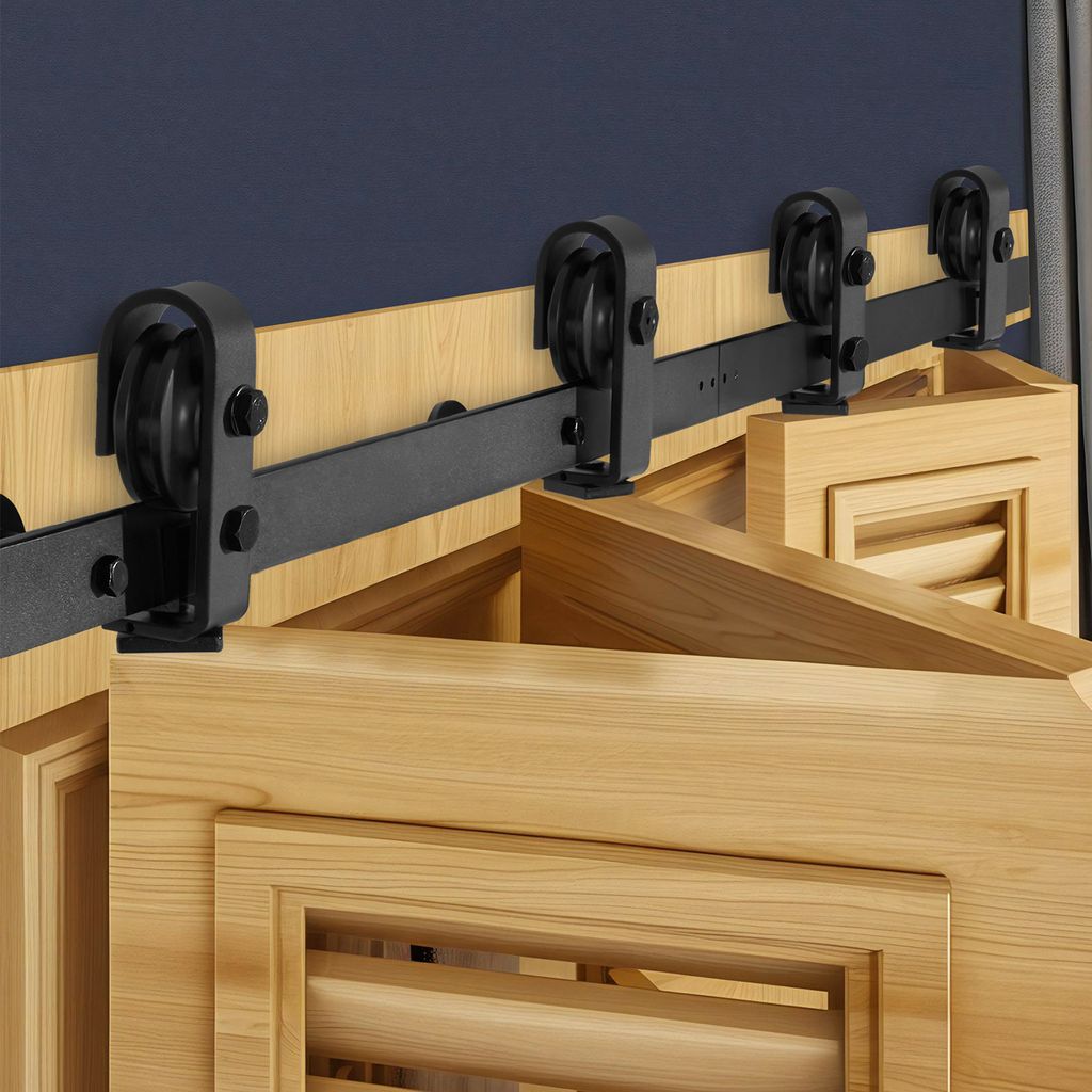 A close-up view of a sliding door hardware system mounted above wooden doors.