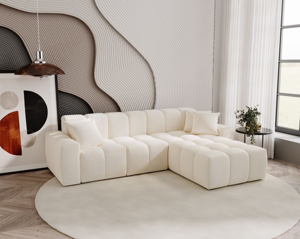 A modern living room with a cream sectional sofa, abstract wall art, and a round rug.