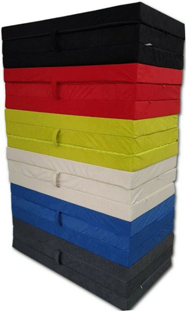 A stack of folded mattresses in various colors.