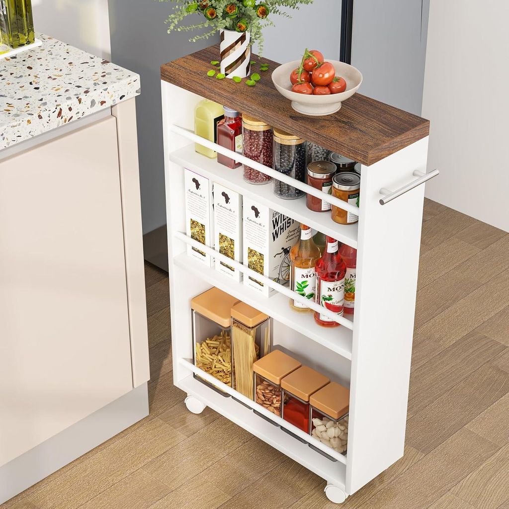 A slim storage cart filled with kitchen items is placed next to a kitchen counter.