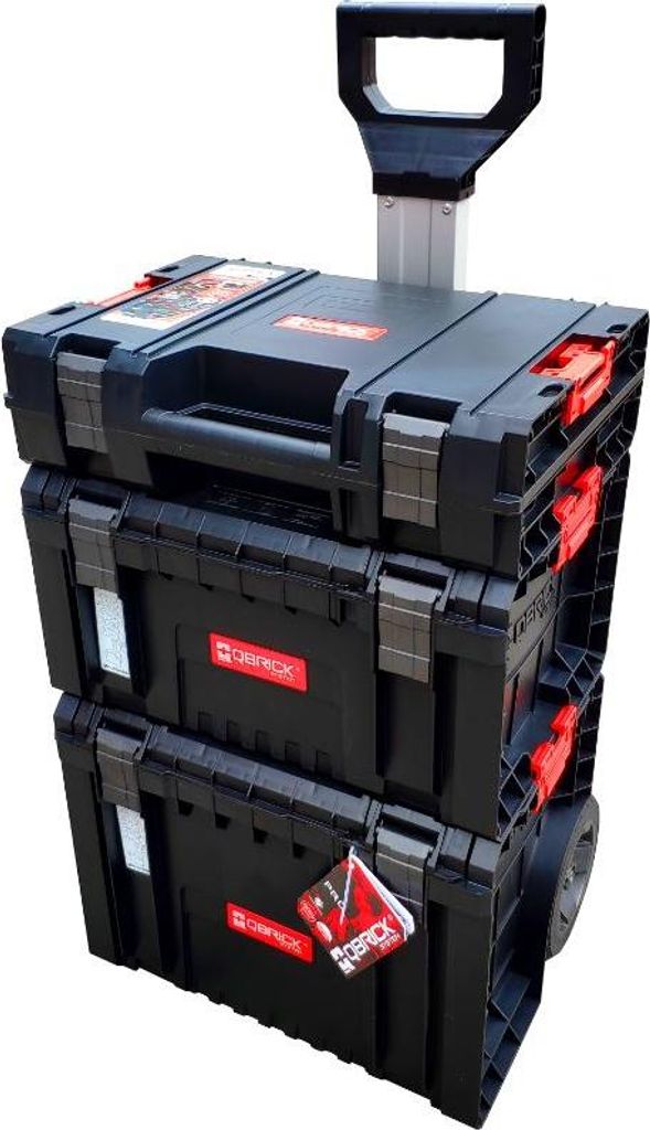 A stack of three black toolboxes with red accents, one on top of the other, with a silver retractable handle and wheels on the bottom unit.