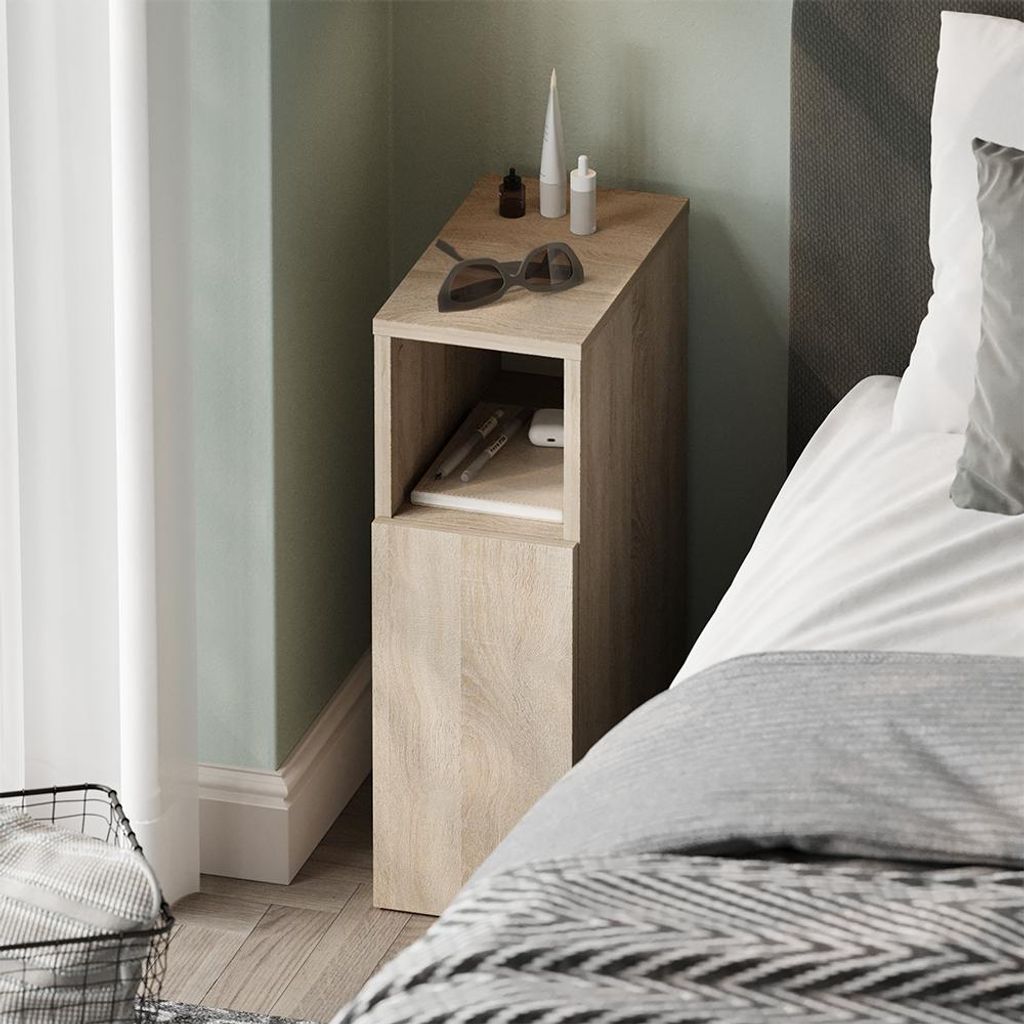 A bedside table next to a bed in a bedroom.