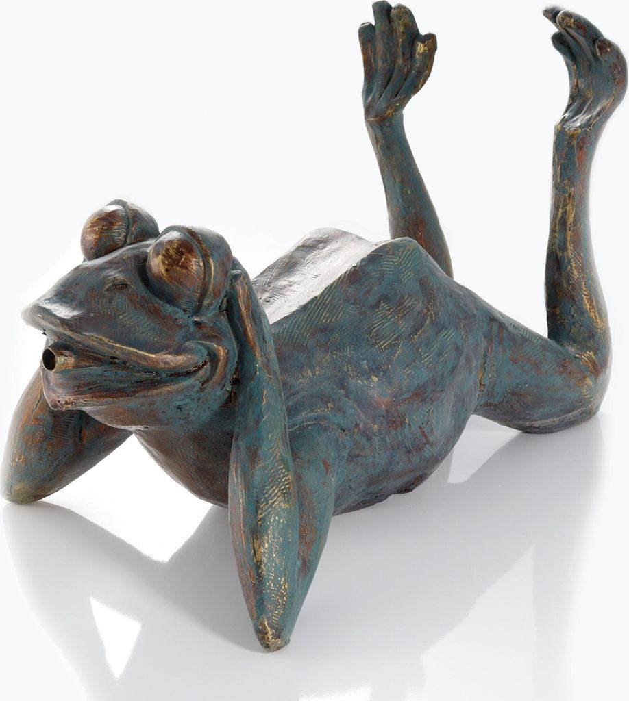 A bronze sculpture of a frog lying on its back with its legs in the air.