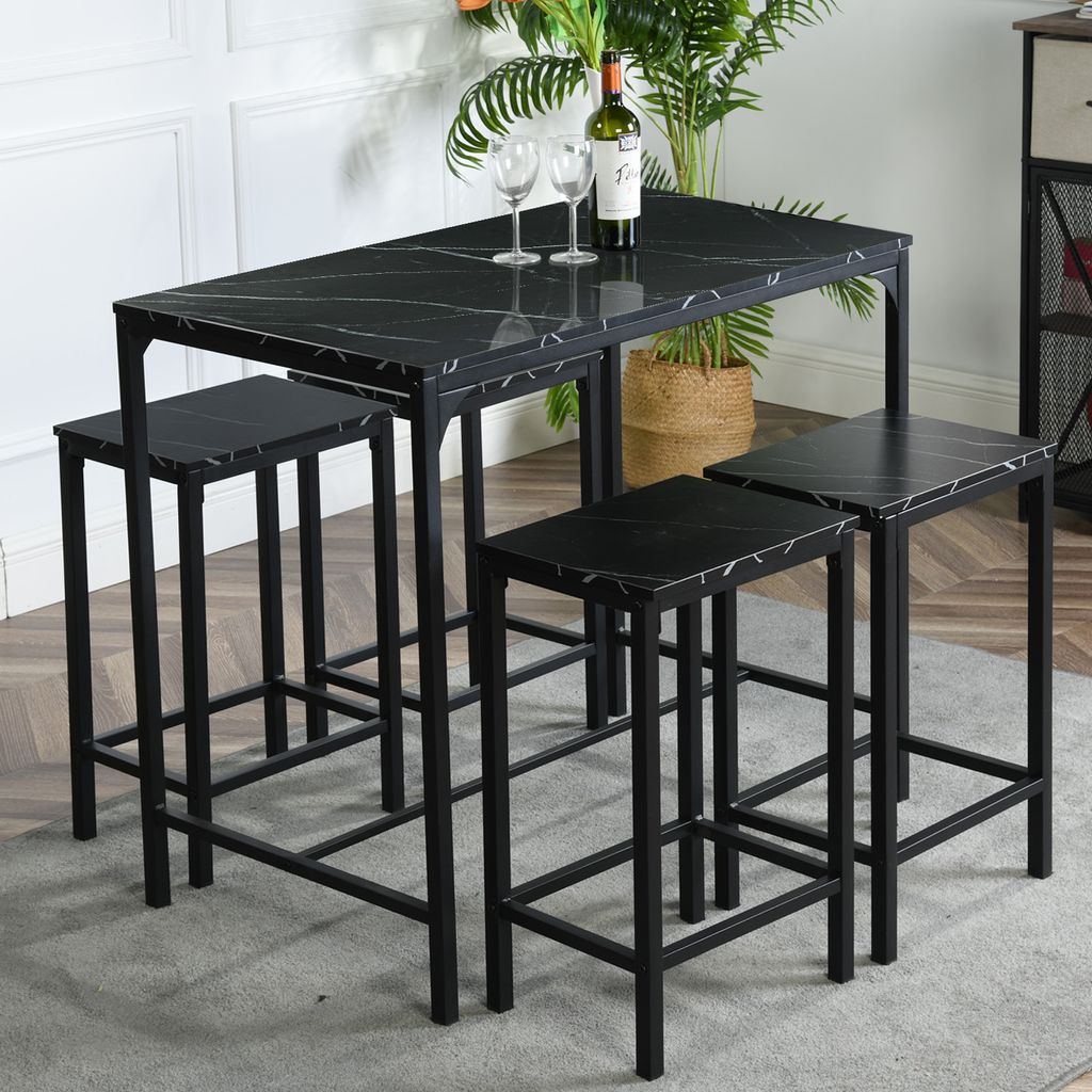 A black marble-patterned dining set with four stools is shown in a room.