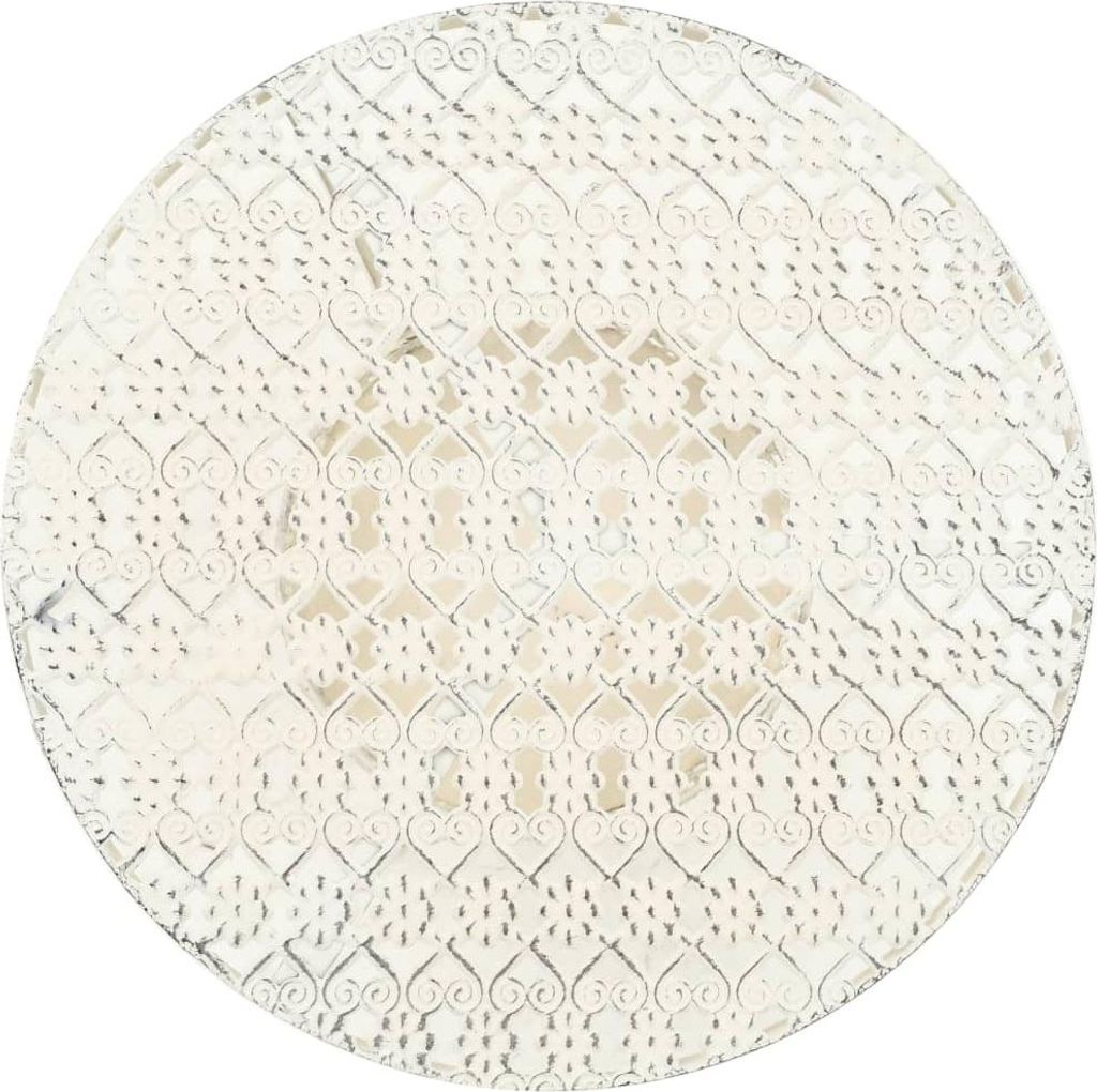 A white round metal bistro table with a decorative heart pattern.